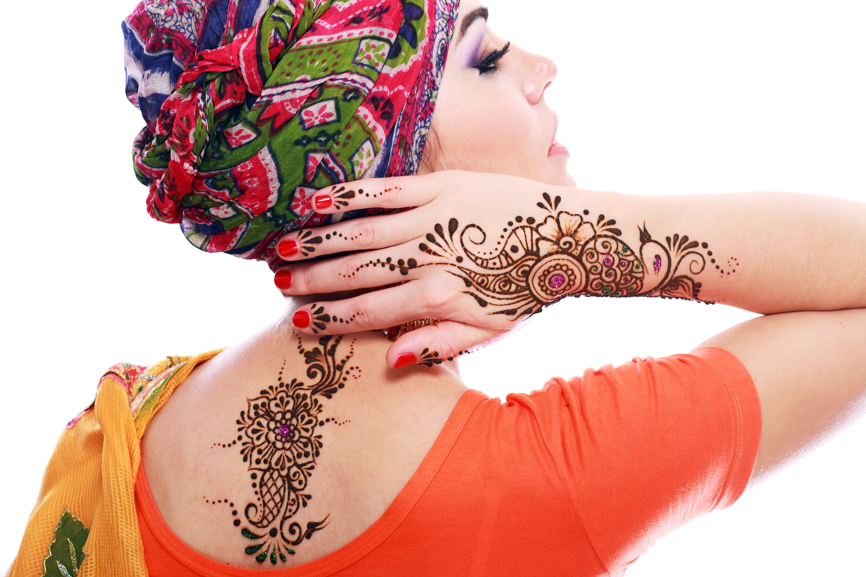 Beautiful woman arabian make up and turban on head with detail of henna being applied to hand and backt isolated