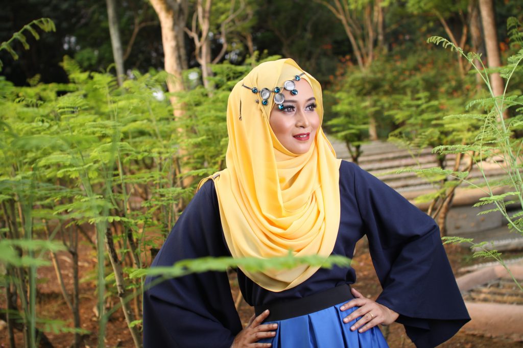 high fashion muslim women posing at wooden background